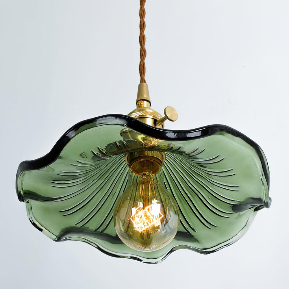 "Hibiscus flower-shaped pendant light in brass and glass, adds elegance and vibrancy to stylish room decor."
