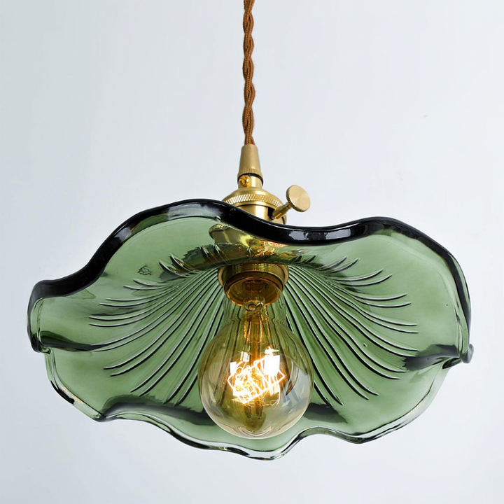 "Hibiscus flower-shaped pendant light in brass and glass, adds elegance and vibrancy to stylish room decor."