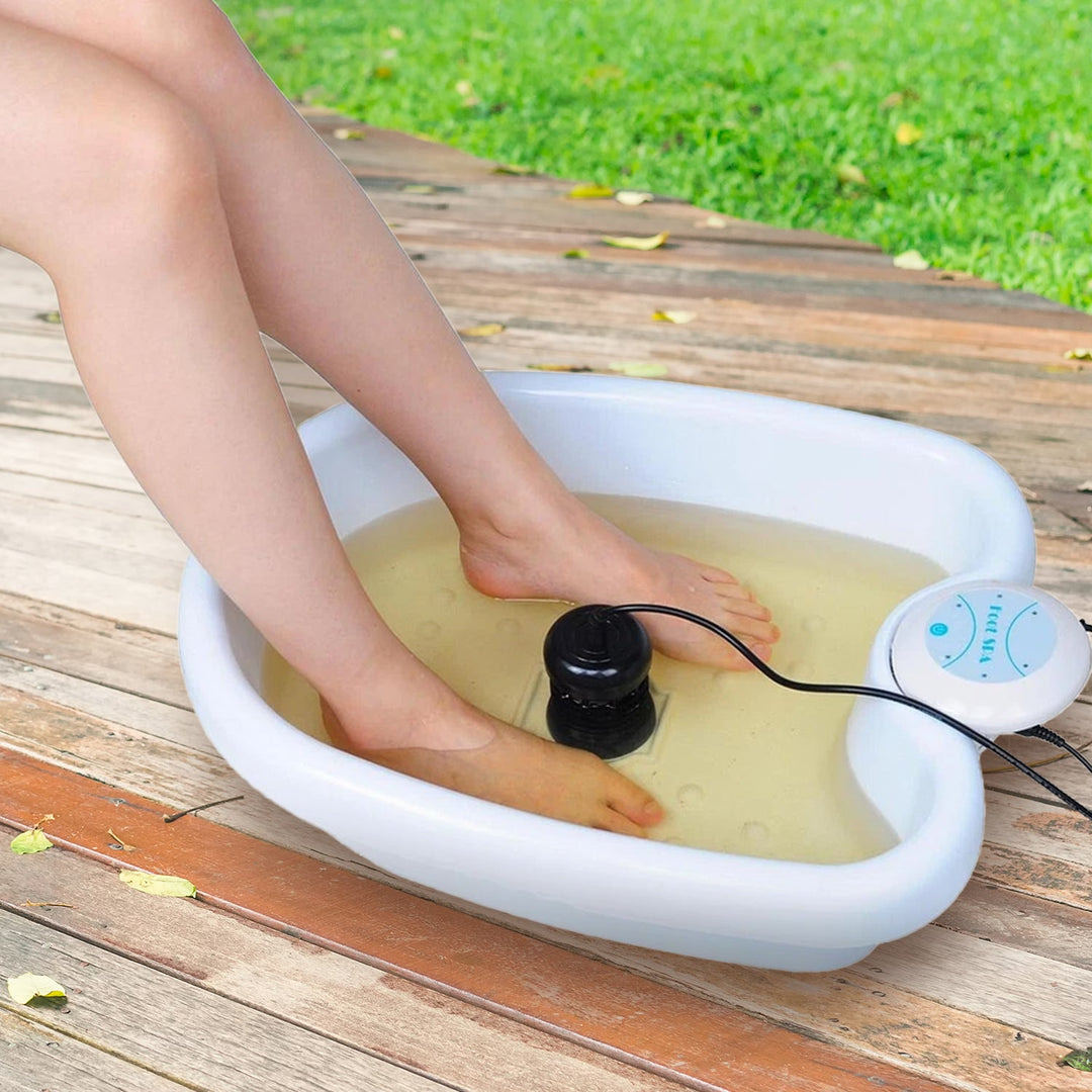 "Ionic Foot Spa for Relaxation & Detox, white plastic tub with water, offers detoxification and tranquility at home."