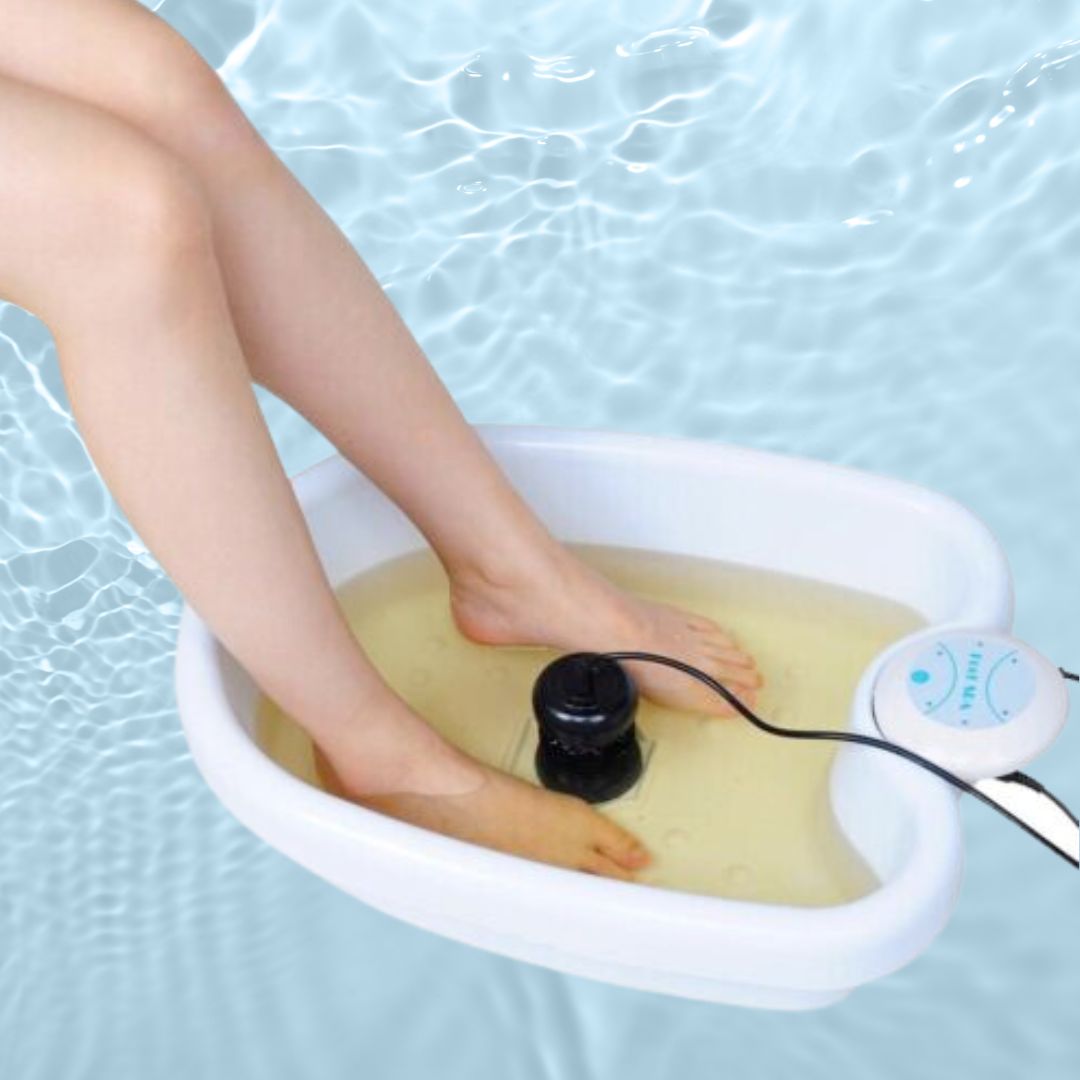 "Ionic Foot Spa for Relaxation & Detox, white plastic tub with water, offers detoxification and tranquility at home."