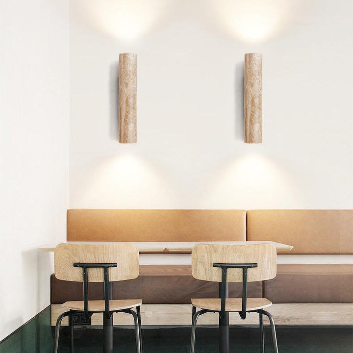 Japandi minimalist travertine stone wall lamp with natural beige finish, conveys elegance with its sleek design and warm glow