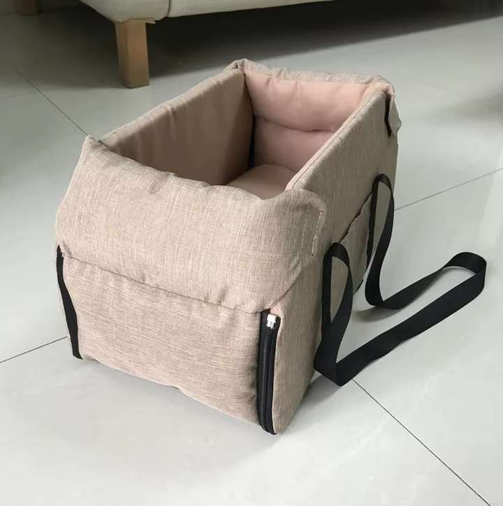 "Luxe padded dog car seat with safety belt, portable for travel, ensuring comfort and security during car journeys."