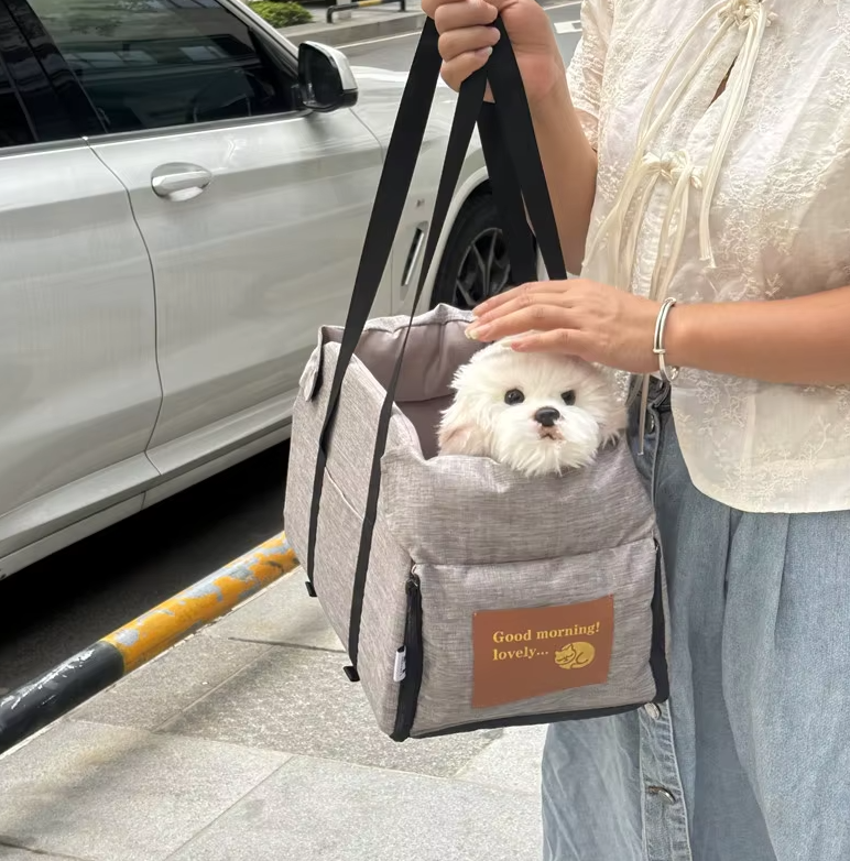 "Luxe padded dog car seat with safety belt, portable for travel, ensuring comfort and security during car journeys."