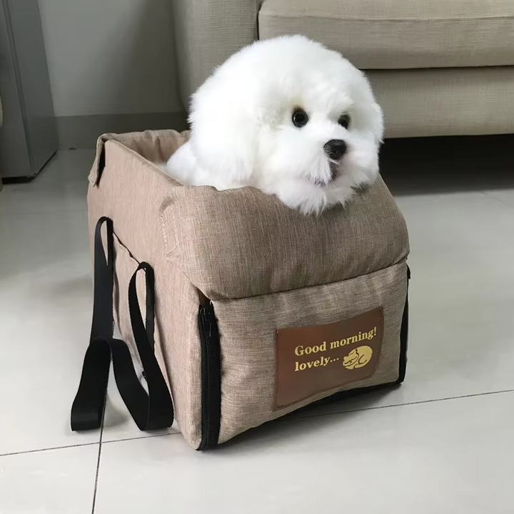 "Luxe padded dog car seat with safety belt, portable for travel, ensuring comfort and security during car journeys."