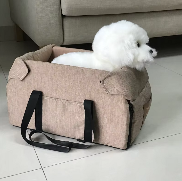"Luxe padded dog car seat with safety belt, portable for travel, ensuring comfort and security during car journeys."