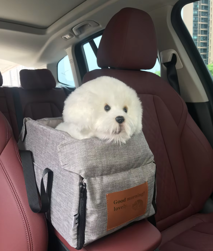 "Luxe padded dog car seat with safety belt, portable for travel, ensuring comfort and security during car journeys."