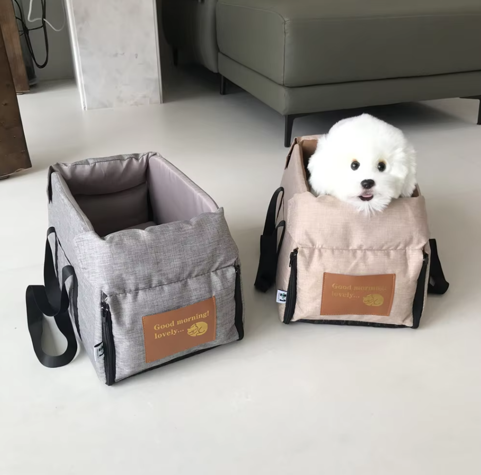 "Luxe padded dog car seat with safety belt, portable for travel, ensuring comfort and security during car journeys."