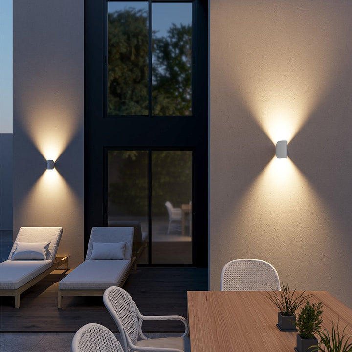 Modern LED up-down wall sconce light in black and white with minimalist design, perfect for indoor ambient lighting.