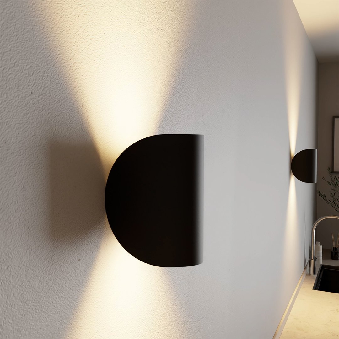 Modern LED up-down wall sconce light in black and white with minimalist design, perfect for indoor ambient lighting.