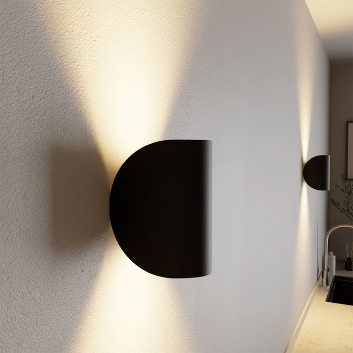 Modern LED up-down wall sconce light in black and white with minimalist design, perfect for indoor ambient lighting.