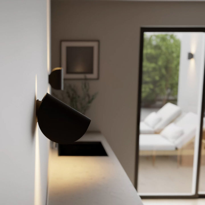 Modern LED up-down wall sconce light in black and white with minimalist design, perfect for indoor ambient lighting.