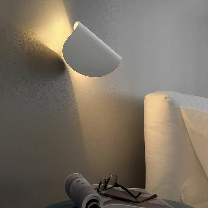 Modern LED up-down wall sconce light in black and white with minimalist design, perfect for indoor ambient lighting.