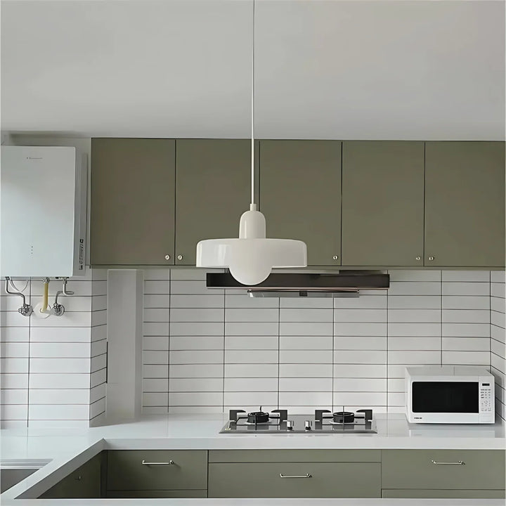 "Modern glass pendant light with sleek glass, brushed metal, ideal for elegant interiors, adds sophistication and warmth."