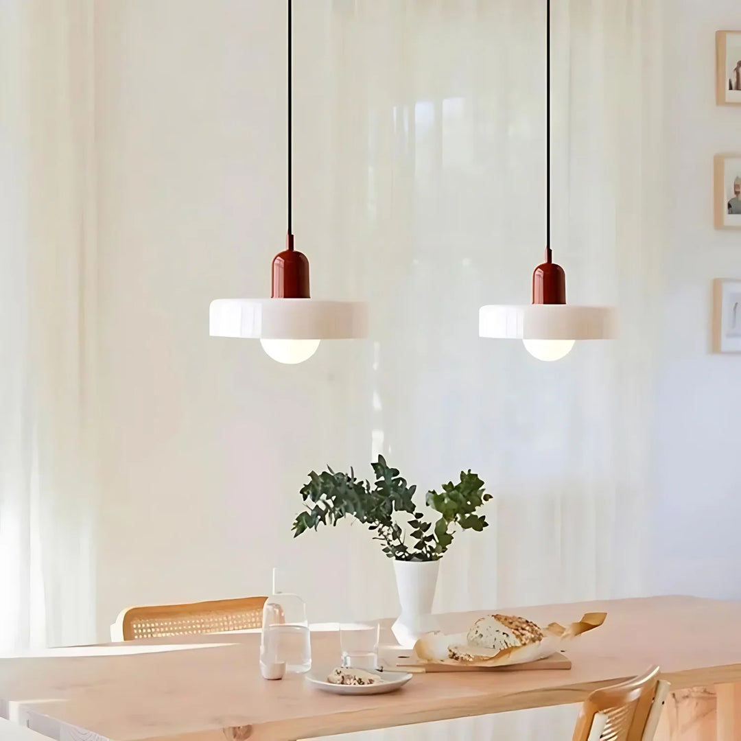 "Modern glass pendant light with sleek glass, brushed metal, ideal for elegant interiors, adds sophistication and warmth."
