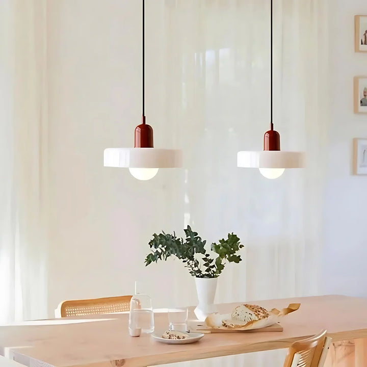 "Modern glass pendant light with sleek glass, brushed metal, ideal for elegant interiors, adds sophistication and warmth."