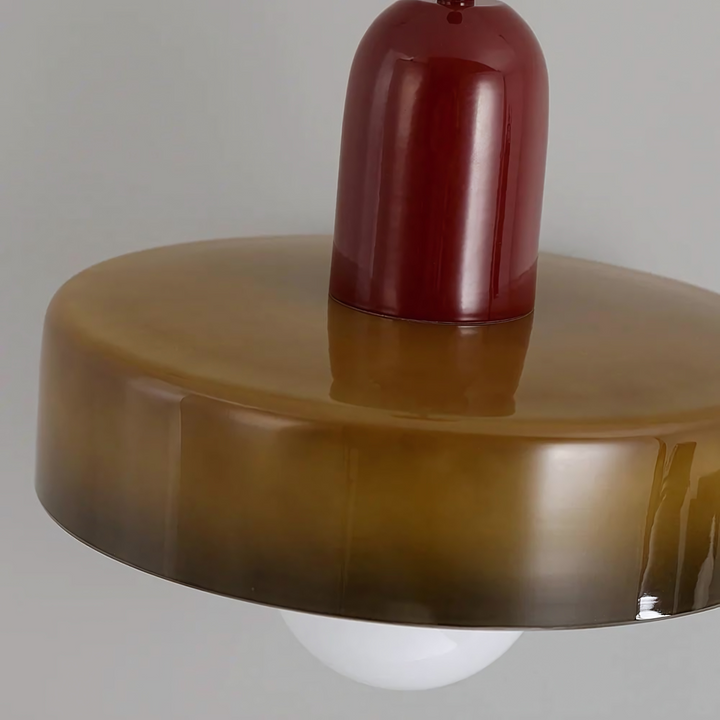"Modern glass pendant light with sleek glass, brushed metal, ideal for elegant interiors, adds sophistication and warmth."