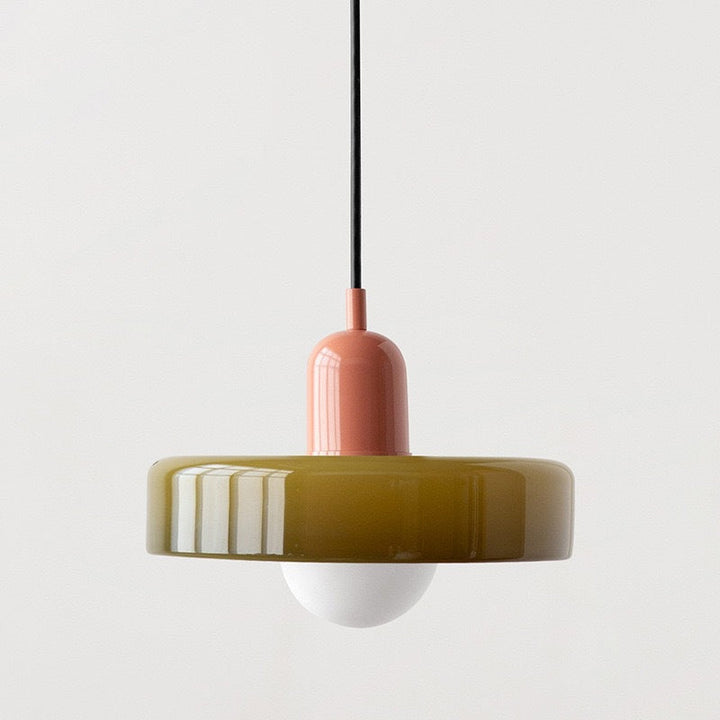 "Modern glass pendant light with sleek glass, brushed metal, ideal for elegant interiors, adds sophistication and warmth."