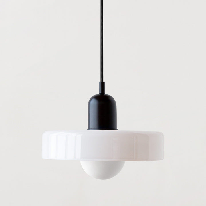 "Modern glass pendant light with sleek glass, brushed metal, ideal for elegant interiors, adds sophistication and warmth."