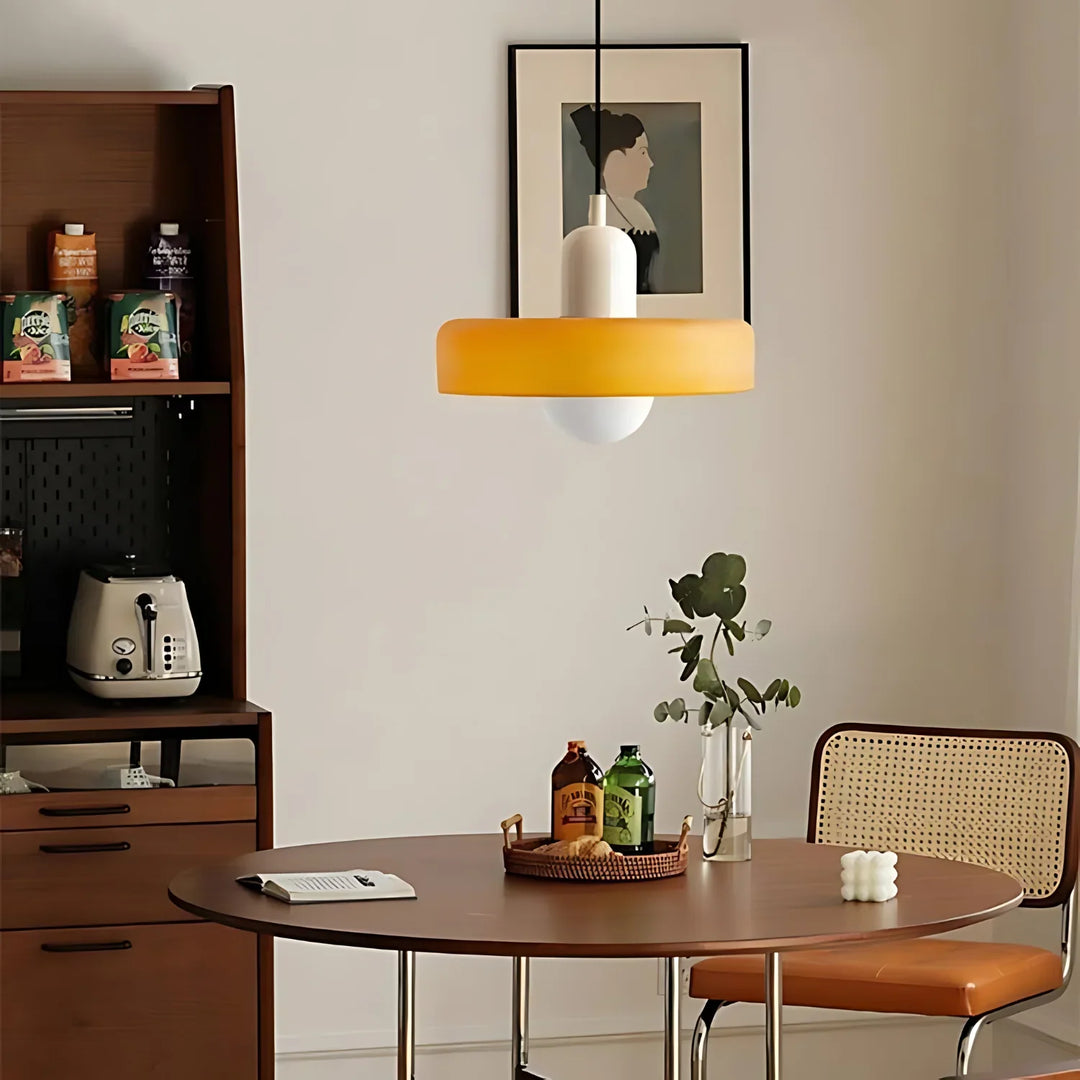 "Modern glass pendant light with sleek glass, brushed metal, ideal for elegant interiors, adds sophistication and warmth."