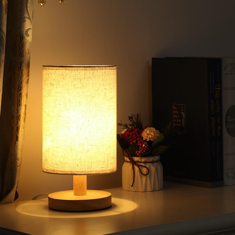 "Modern wooden bedside table lamp with remote, dimmable LED, natural wood look, elegant design for bedroom or living room."