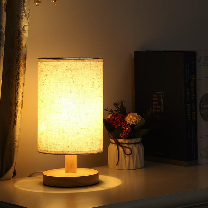 "Modern wooden bedside table lamp with remote, dimmable LED, natural wood look, elegant design for bedroom or living room."