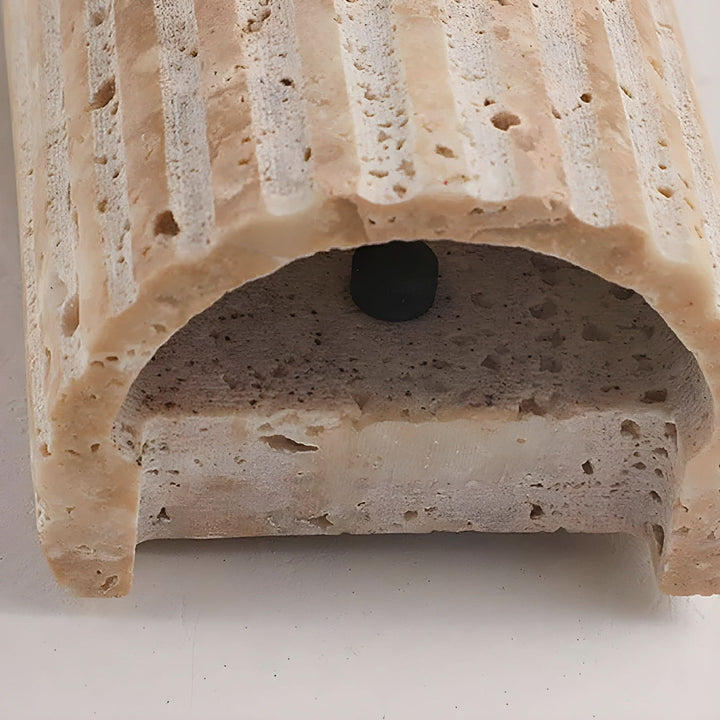 "Natural stone wall lamp with warm LED glow, showcasing organic texture and ambient lighting for modern interiors."