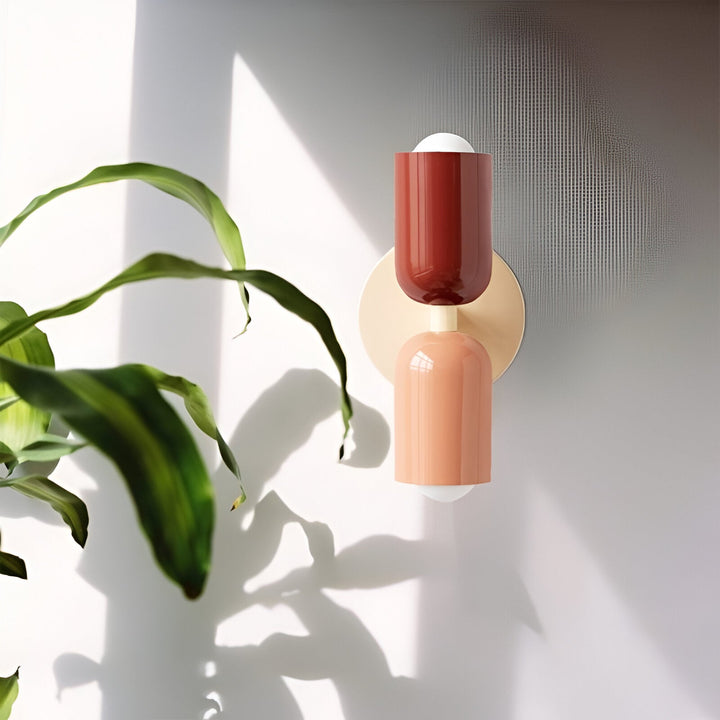 Nordic colourful double head wall light in vibrant colors, painted iron, sleek cylindrical design, casts light up and down.