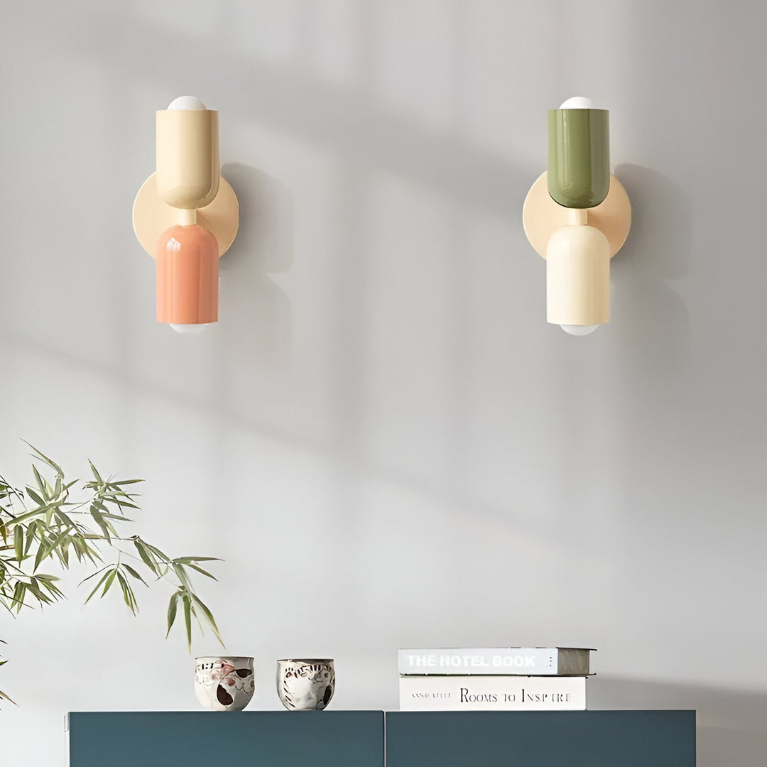 Nordic colourful double head wall light in vibrant colors, painted iron, sleek cylindrical design, casts light up and down.