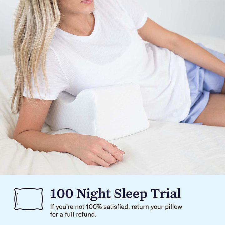 Orthopaedic cushion, white memory foam, ergonomically contoured for hip, knee, and back pain relief, size 24x21x14.5 cm.