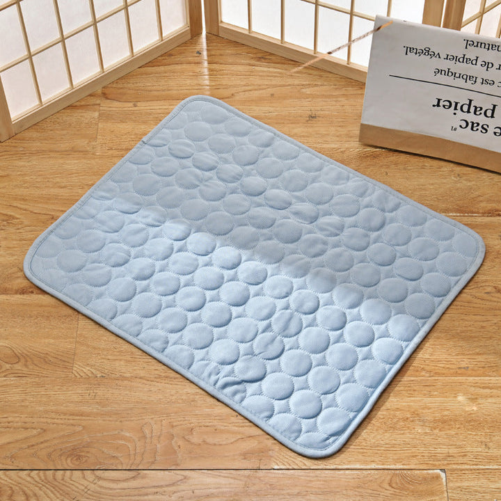 Pet cooling mat in calming colors, offers instant cooling relief with soft padding for pets indoors and outdoors.