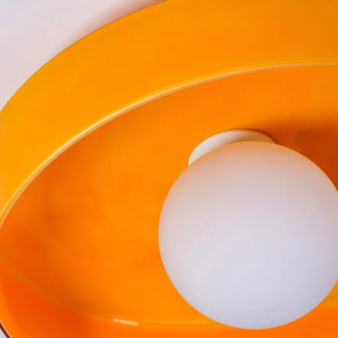 "Round ceiling lamp of high-quality glass in vibrant orange, stylish design, perfect for modern interiors, enhancing any spac