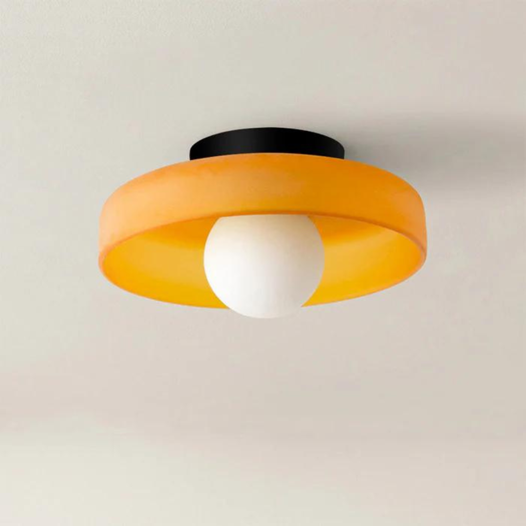 "Round ceiling lamp of high-quality glass in vibrant orange, stylish design, perfect for modern interiors, enhancing any spac