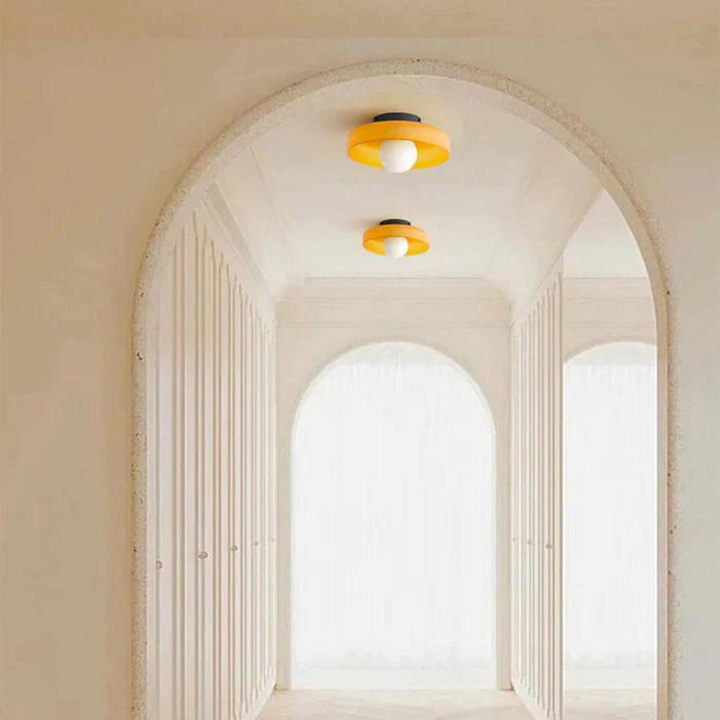"Round ceiling lamp of high-quality glass in vibrant orange, stylish design, perfect for modern interiors, enhancing any spac