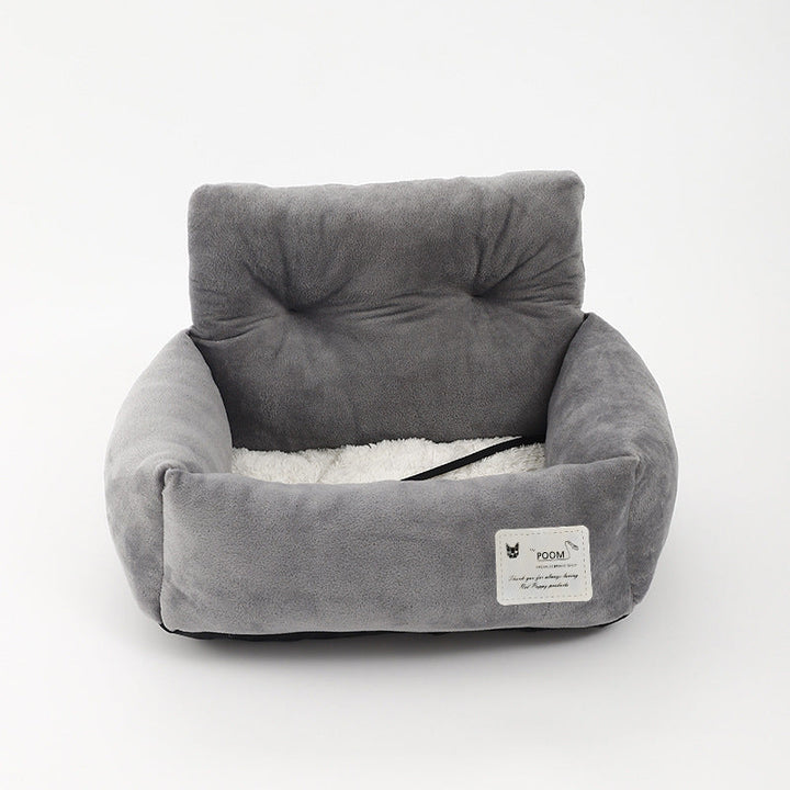 "Soft cushioned dog car seat with safety straps for secure travel, fitting most vehicles, ideal for comfortable pet journeys.