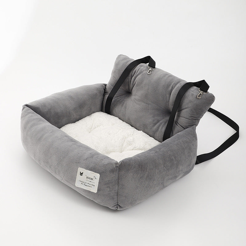 "Soft cushioned dog car seat with safety straps for secure travel, fitting most vehicles, ideal for comfortable pet journeys.