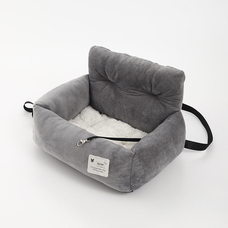 "Soft cushioned dog car seat with safety straps for secure travel, fitting most vehicles, ideal for comfortable pet journeys.