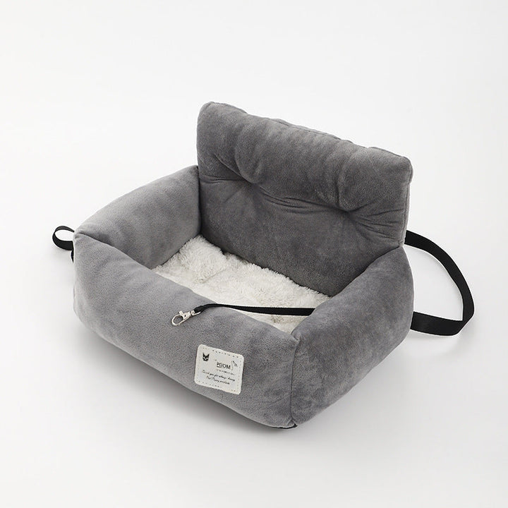 "Soft cushioned dog car seat with safety straps for secure travel, fitting most vehicles, ideal for comfortable pet journeys.