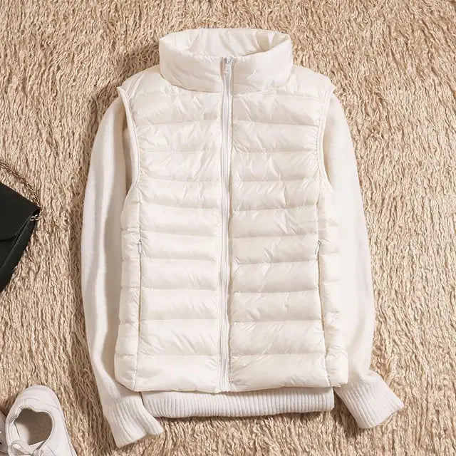"Ultra-light women's autumn down vest in sleek fit, available in Black, Blue, Khaki; stylish and packable for cool days."