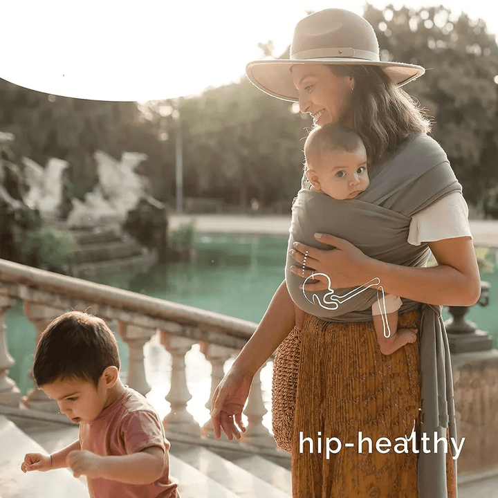 "Unisex ergonomic baby wrap carrier, grey, enveloping baby and parent comfortably for hands-free convenience."