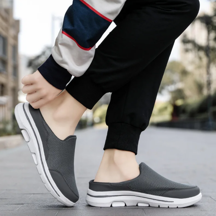 Unisex slip-on sports shoes with breathable mesh, cushioned insole, and sleek design in grey, black, blue, and brown.