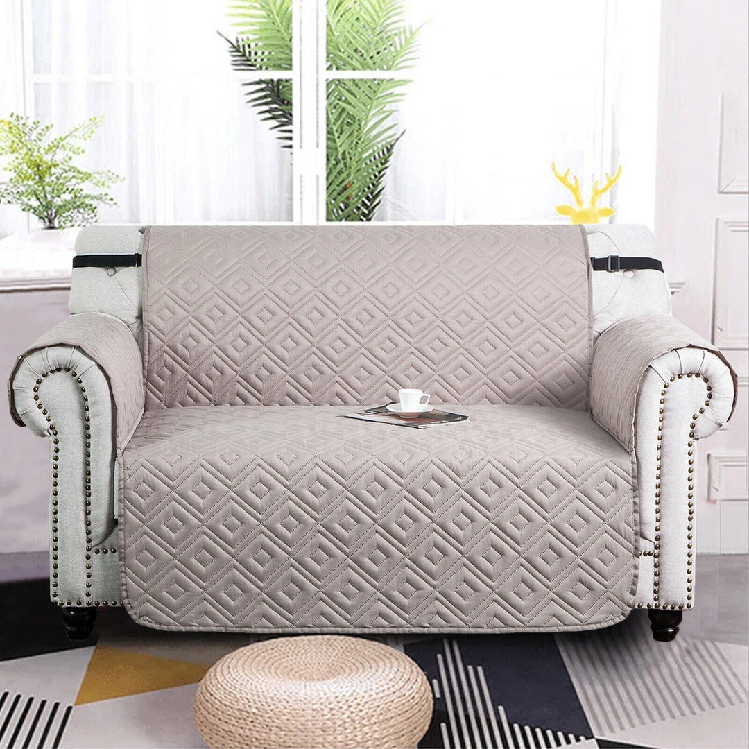"Water-repellent non-slip reversible sofa cover protecting couch from spills and stains with pet sitting on it"