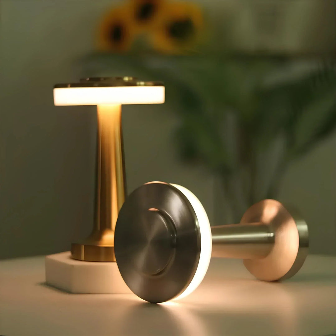 "Wireless retro table lamp with luxurious metallic finish, dimmable LED light, versatile cordless design for any setting."