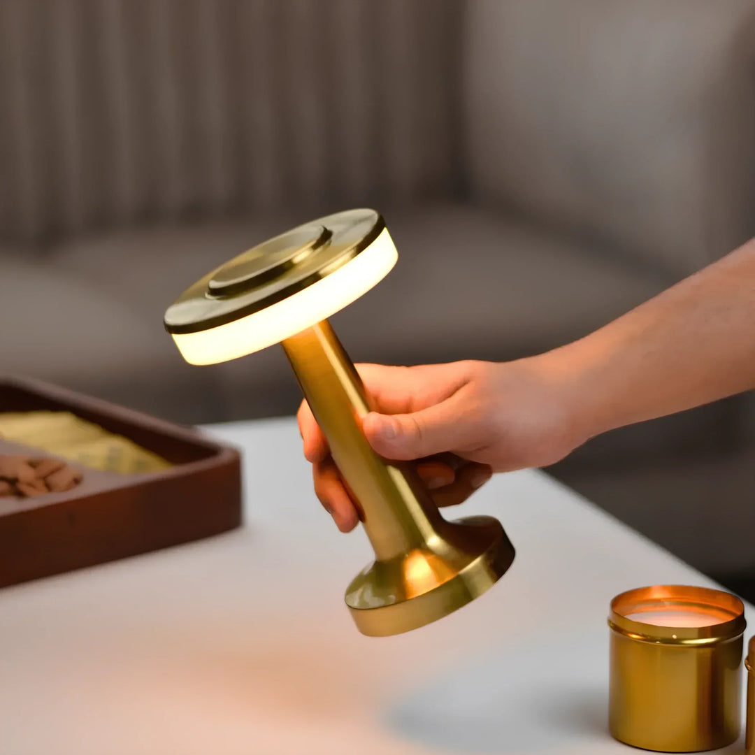 "Wireless retro table lamp with luxurious metallic finish, dimmable LED light, versatile cordless design for any setting."