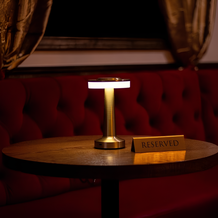 "Wireless retro table lamp with luxurious metallic finish, dimmable LED light, versatile cordless design for any setting."