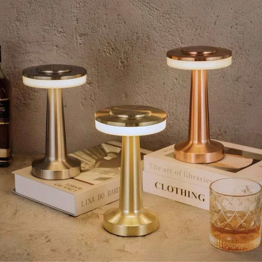 "Wireless retro table lamp with luxurious metallic finish, dimmable LED light, versatile cordless design for any setting."