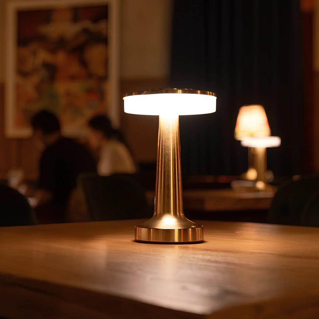 "Wireless retro table lamp with luxurious metallic finish, dimmable LED light, versatile cordless design for any setting."