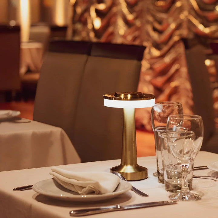 "Wireless retro table lamp with luxurious metallic finish, dimmable LED light, versatile cordless design for any setting."