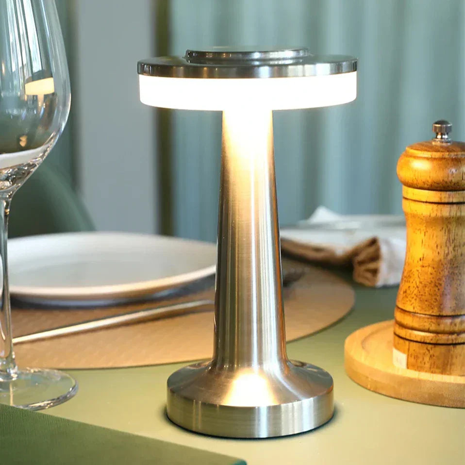 "Wireless retro table lamp with luxurious metallic finish, dimmable LED light, versatile cordless design for any setting."