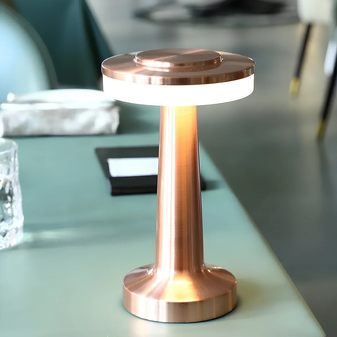 "Wireless retro table lamp with luxurious metallic finish, dimmable LED light, versatile cordless design for any setting."