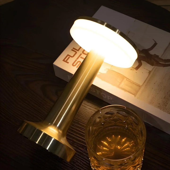 "Wireless retro table lamp with luxurious metallic finish, dimmable LED light, versatile cordless design for any setting."